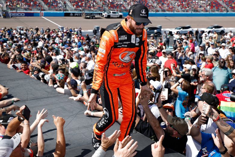 Ross Chastain walks across the stage and greets fans.