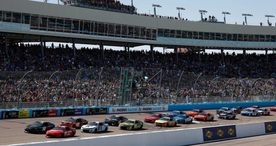 NASCAR Cup Series cars cross the start/finish line at Phoenix Raceway.