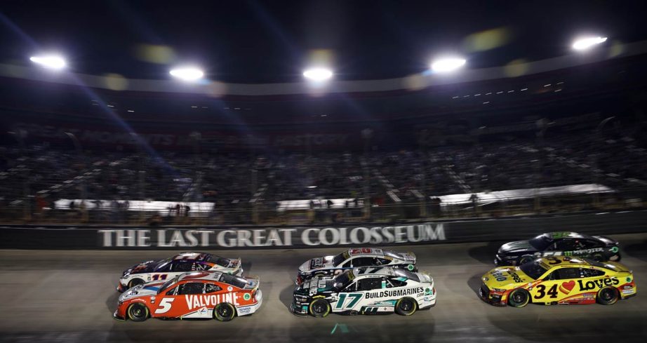 NASCAR Cup Series cars round a turn at Bristol Motor Speedway.