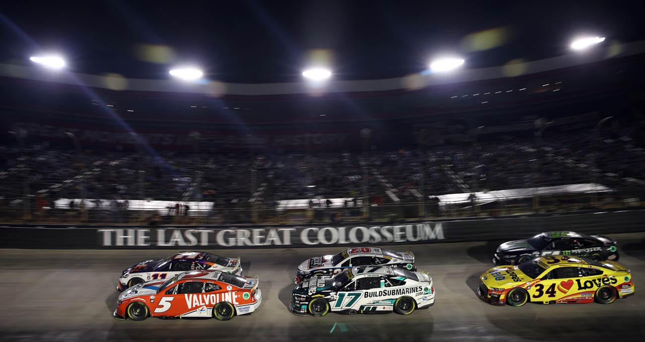 NASCAR Cup Series cars round a turn at Bristol Motor Speedway.