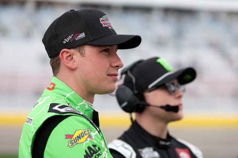 Christopher Bell, foreground, and Ty Gibbs, background, look on.
