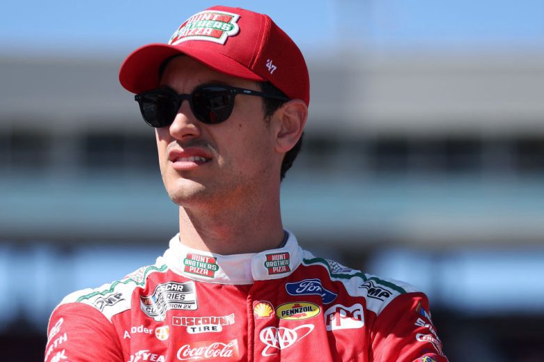 Joey Logano looks on.