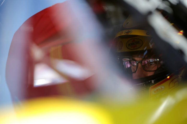 Joey Logano looks on.