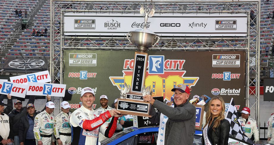 Denny Hamlin holds up trophy