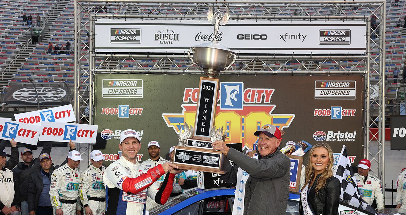 Denny Hamlin holds up trophy