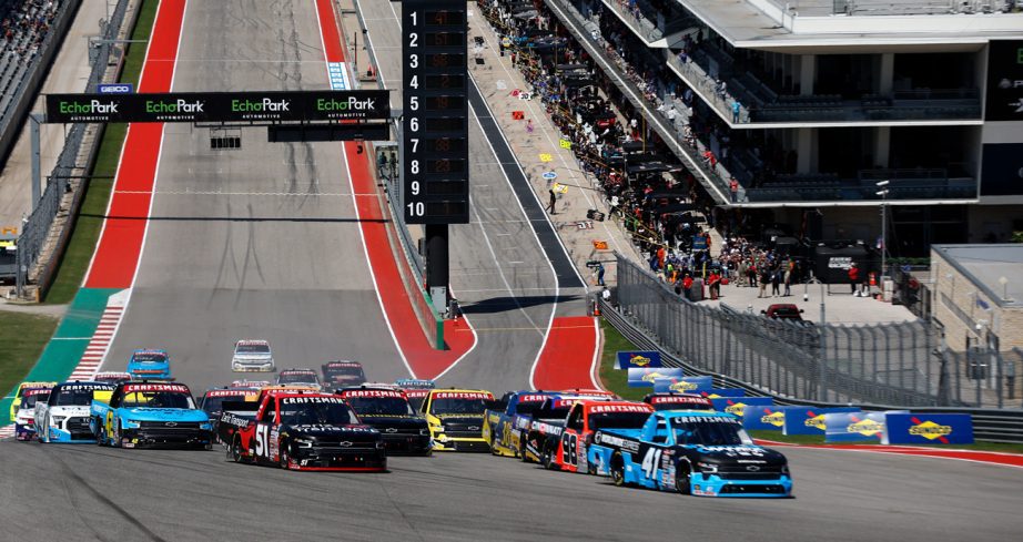 View of NASCAR trucks racing up the hill