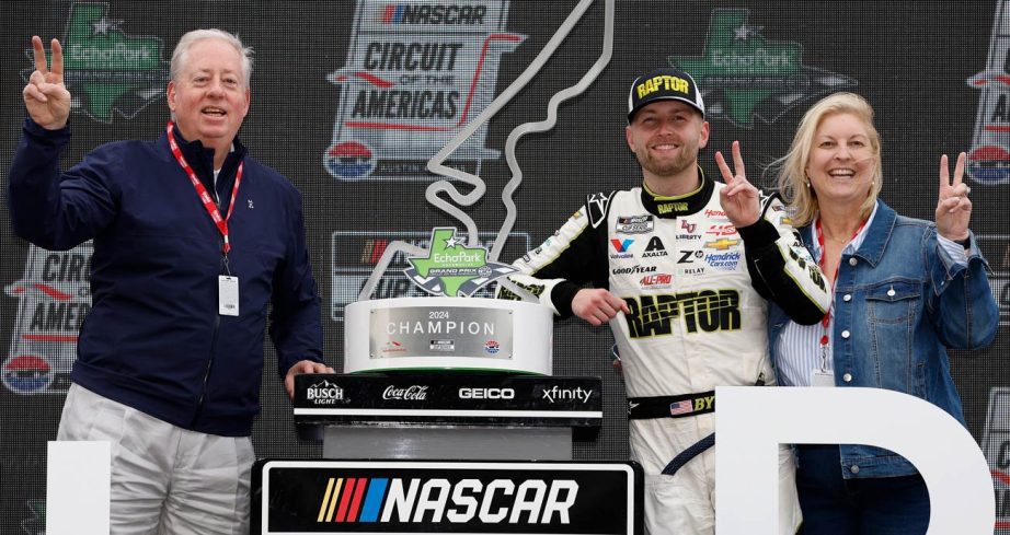 William Byron, center, celebrates with his mother, Dana Byron (right) and father, Bill Byron (left) in Victory Lane after winning at Circuit of The Americas.