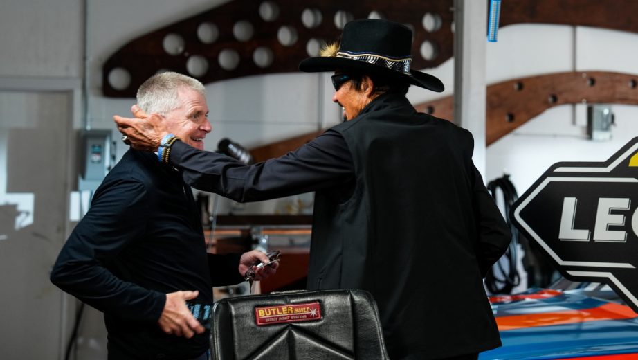 Jeff Burton (left) is greeted by Richard Petty (right) during a video shoot.