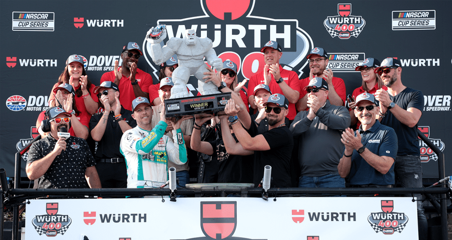 Denny holds up trophy with No. 11 crew