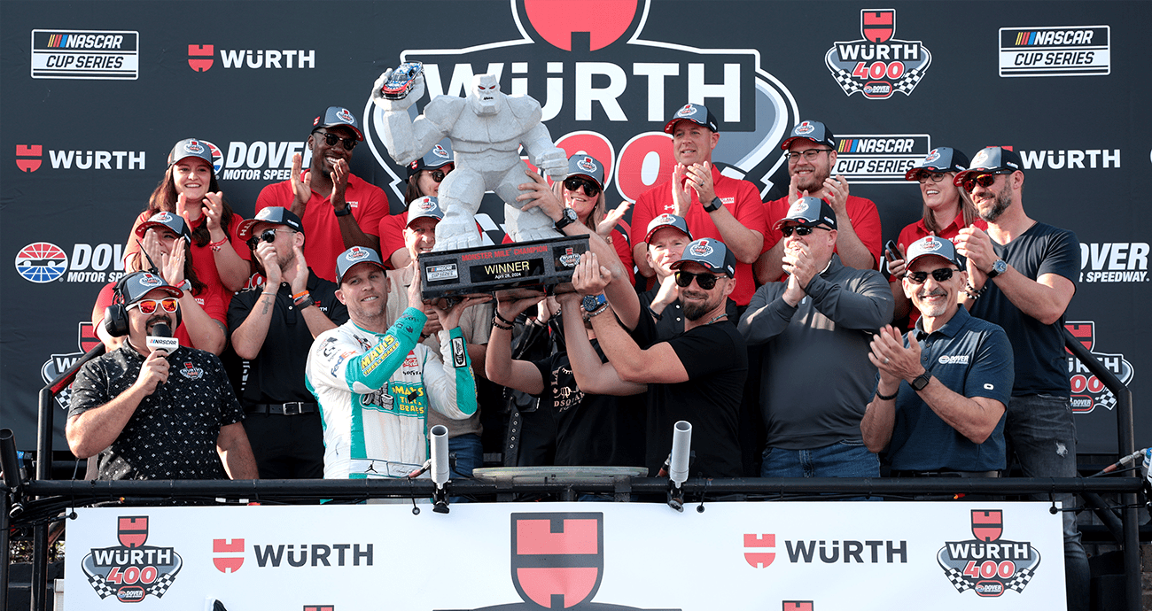 Denny holds up trophy with No. 11 crew