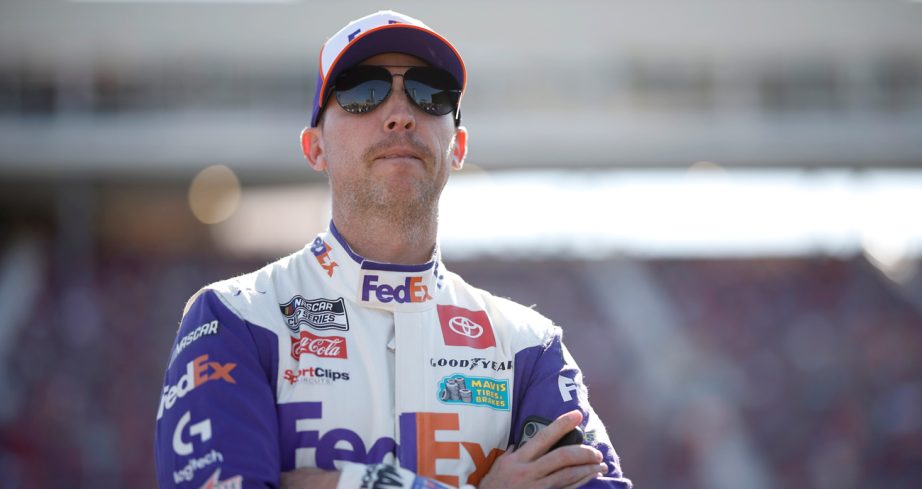 Denny Hamlin stands on pit road during NASCAR Cup Series qualifying.