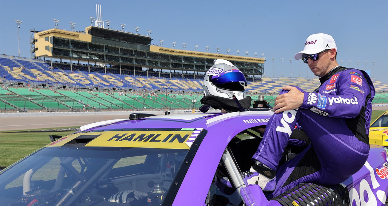 denny hamlin climbs into his car at kansas
