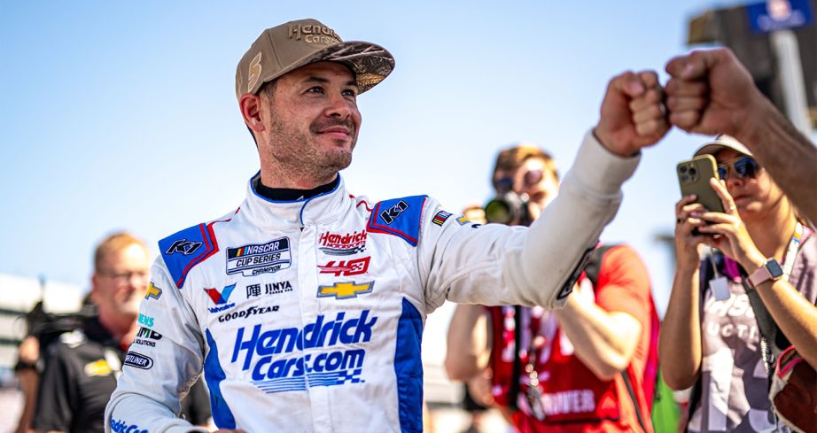 Kyle Larson gives a fist-bump to a crewman after NASCAR Cup Series qualifying.