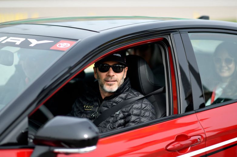 Jimmie Johnson poses for a photo while driving the pace car at Kansas Speedway.