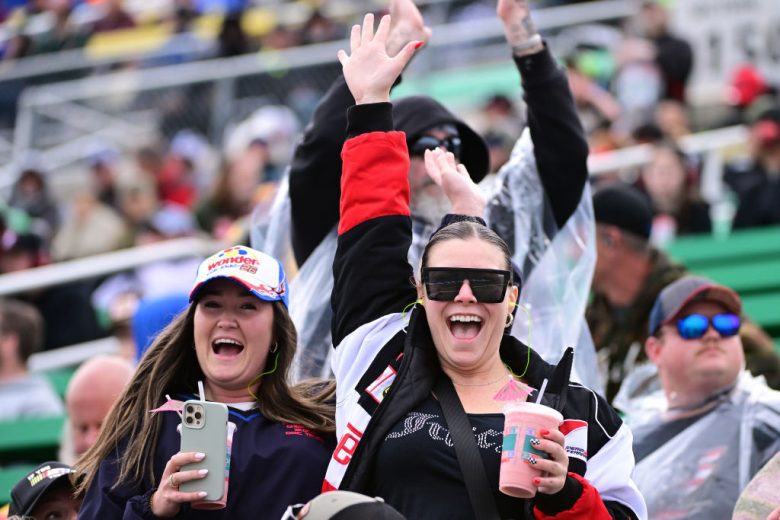 NASCAR fans smile at Kansas Speedway.