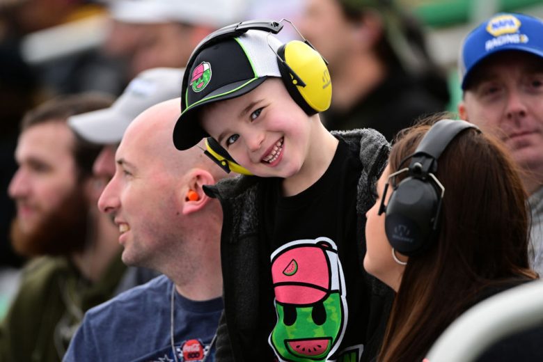 A NASCAR fan smiles at Kansas Speedway.