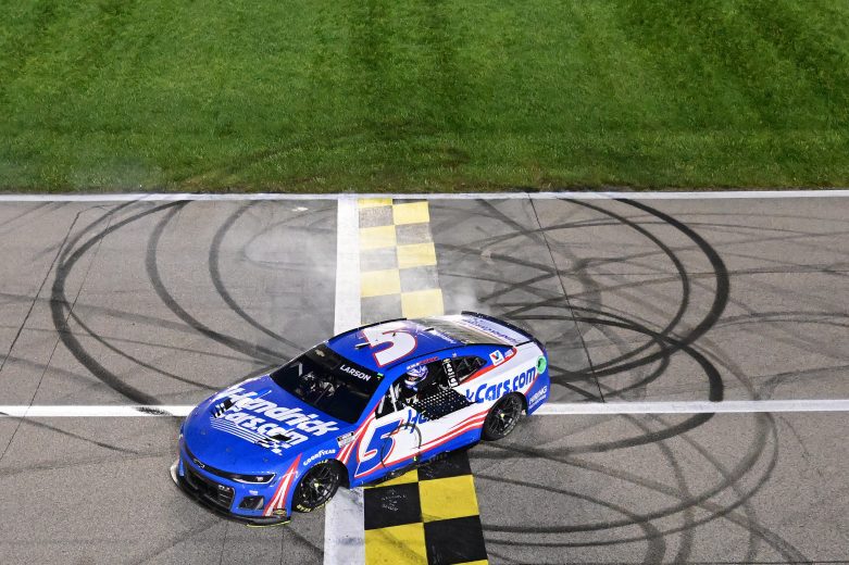 Kyle Larson, driver of the No. 5 HendrickCars.com Chevrolet, celebrates with a burnout after winning the NASCAR Cup Series AdventHealth 400 at Kansas Speedway.