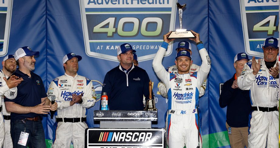 Kyle Larson, driver of the No. 5 HendrickCars.com Chevrolet, celebrates in victory lane after winning the NASCAR Cup Series AdventHealth 400 at Kansas Speedway.