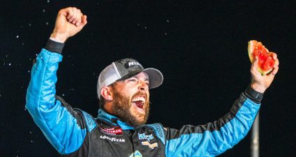 Ross Chastain celebrates his Truck Series win at Darlington in Victory Lane while holding a piece of watermelon.