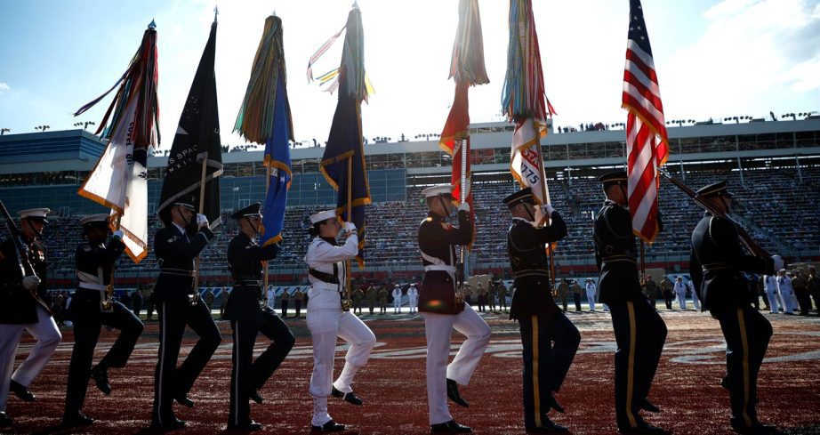 United States military members march with the colors before the Coca-Cola 600 at Charlotte Motor Speedway.