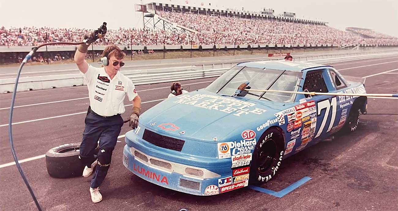 Mike Trower works to change tires on Dave Marcis' No. 71 Chevrolet during a pit stop at Pocono Raceway