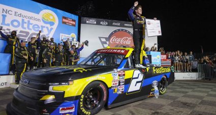 Nick Sanchez stands atop his No. 2 Chevrolet in Victory Lane with his pit crew behind him following his NASCAR Craftsman Truck Series win at Charlotte Motor Speedway.