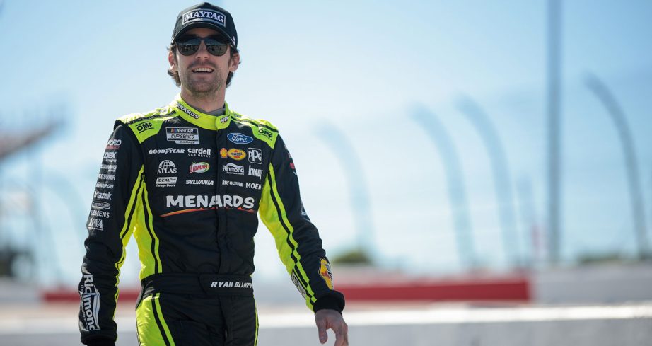 Ryan Blaney walks the grid at Darlington smiling.