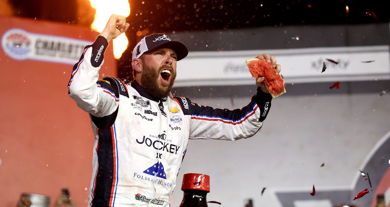 Ross Chastain celebrates in Victory Lane with watermelon in his left hand after winning the 2025 Coca-Cola 600 at Charlotte Motor Speedway.