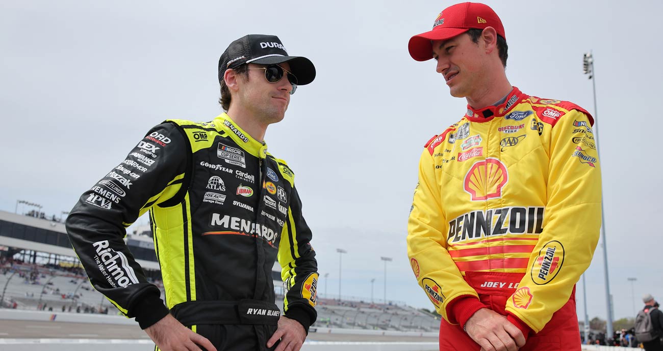 Ryan Blaney (L) and Joey Logano (R) talk.