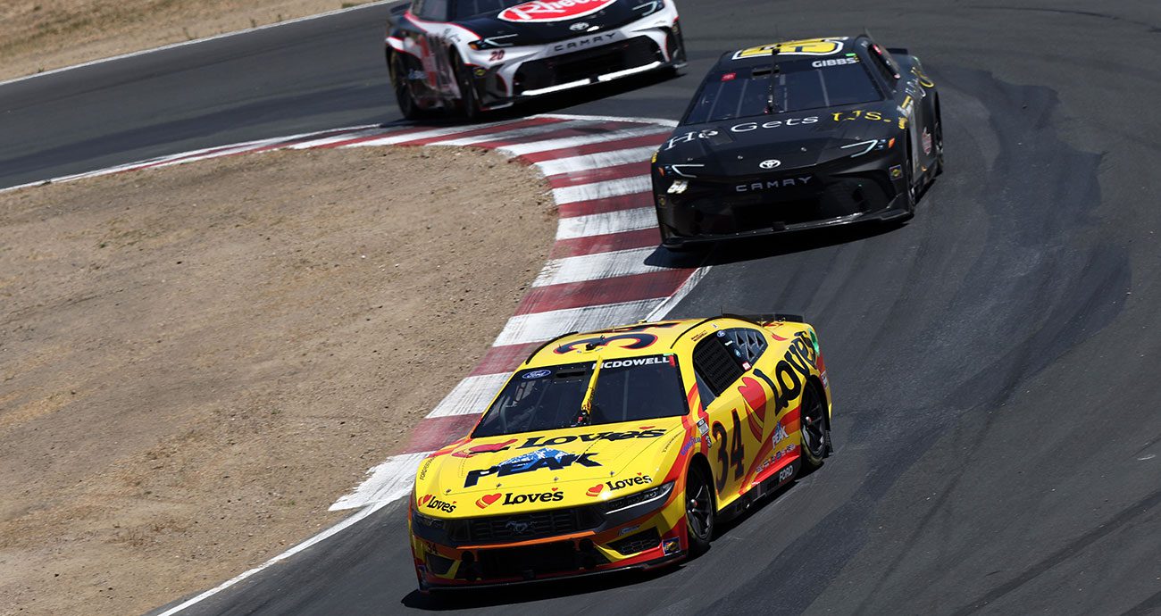 The No. 34 of Michael McDowell drives in the esses at Sonoma, ahead of Ty Gibbs