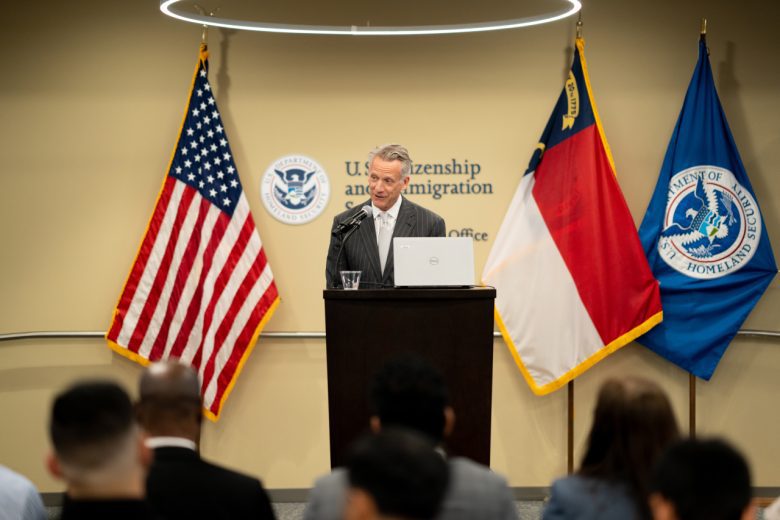 NASCAR President Steve Phelps talks on stage during the naturalization ceremony.
