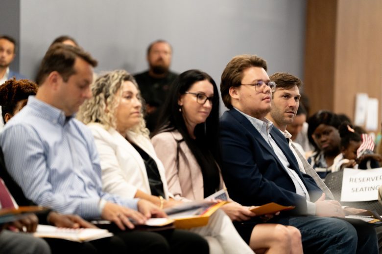 Daniel Suárez (right) looks on during his naturalization ceremony.