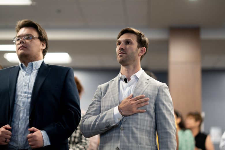 Daniel Suárez places his hand over his heart during a naturalization ceremony.