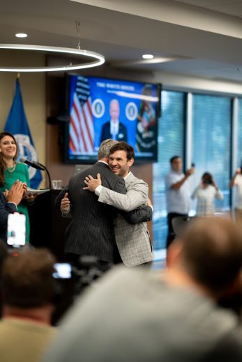 Daniel Suárez embraces NASCAR President Steve Phelps following Suárez's naturalization ceremony.