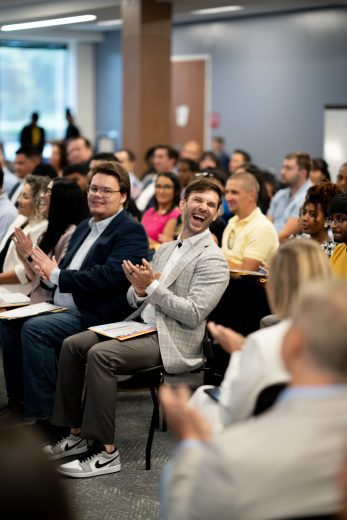 Daniel Suárez claps and laughs in celebration during Tuesday's naturalization ceremony.