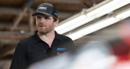 Conor Daly looks on.