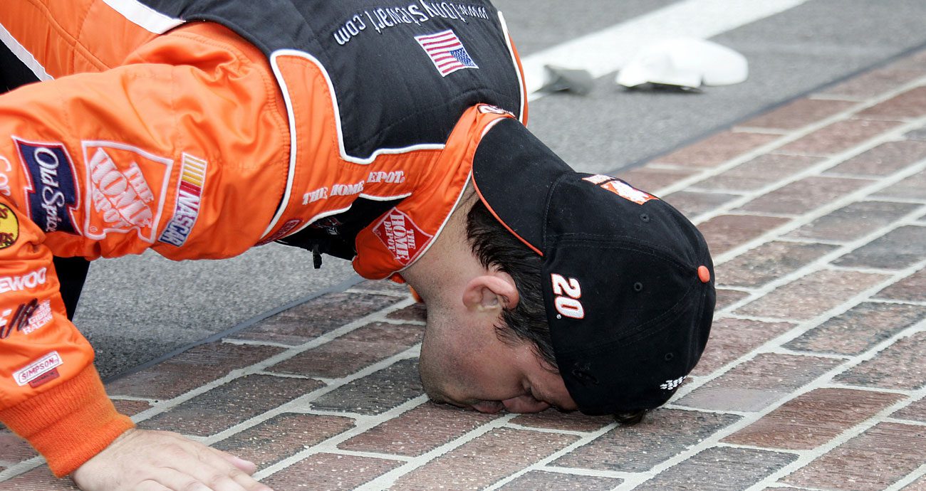 Tony Stewart kisses the bricks after winning the Brickyard 400 in 2005.