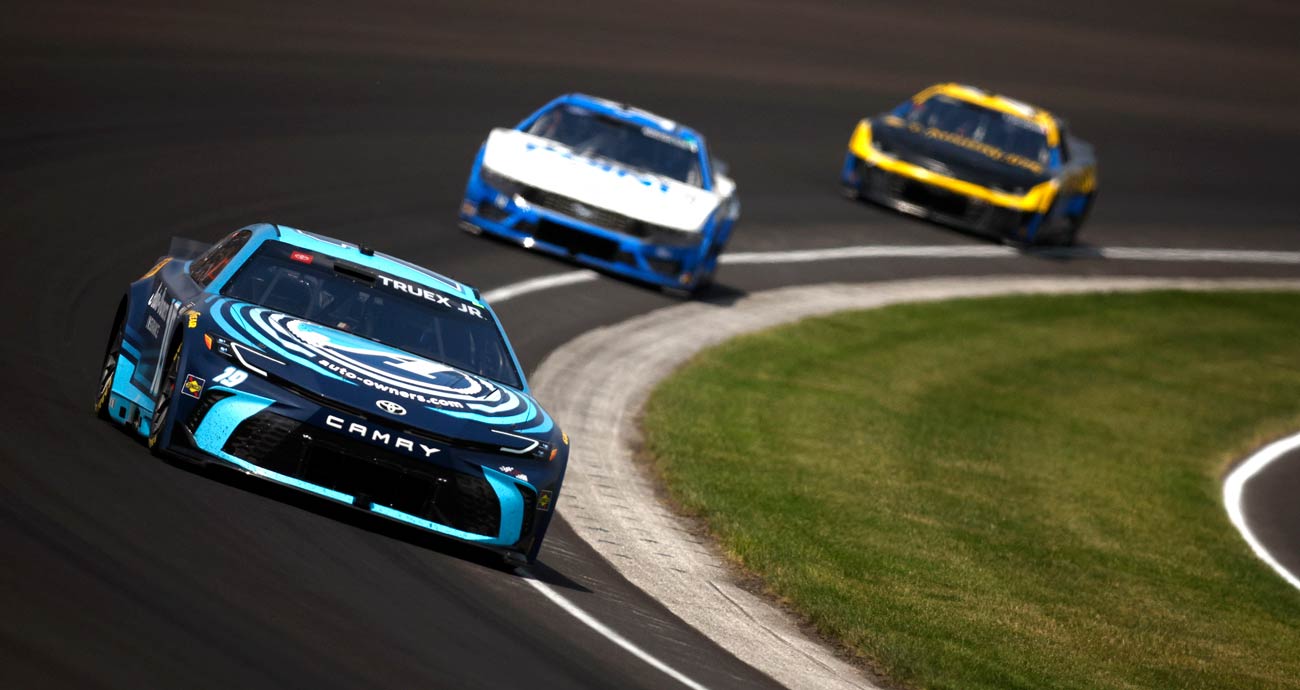 Martin Truex Jr., in the No. 19 Joe Gibbs Racing Toyota, races through a turn at Indianapolis Motor Speedway.