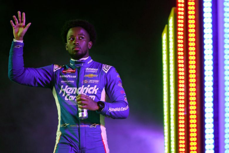 Rajah Caruth waves to the crowd before a NASCAR Cup Series race.