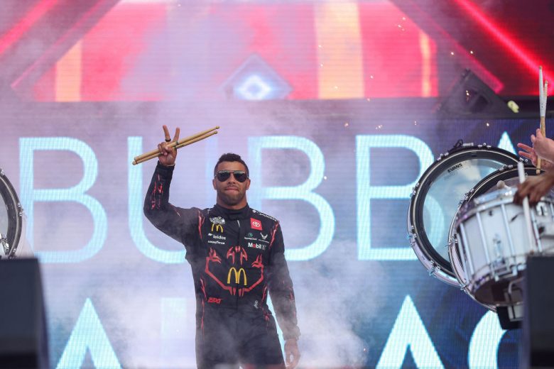 Bubba Wallace waves to the crowd before a NASCAR Cup Series race.