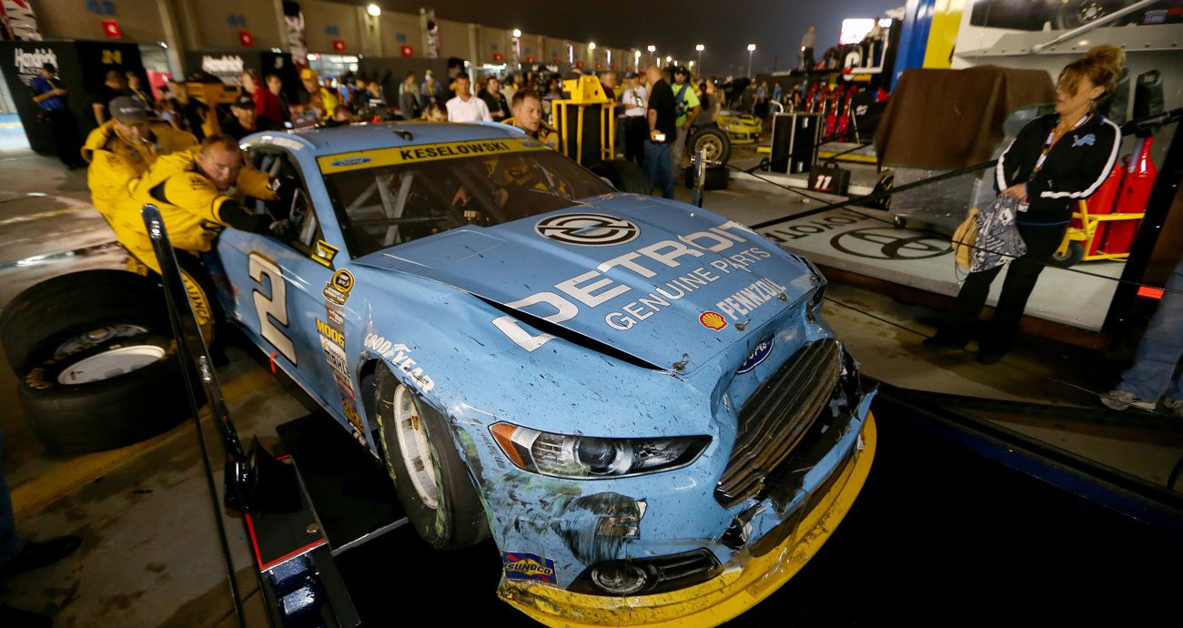 Brad Keselowski's wrecked No. 2 Ford is pushed through the garage area at Charlotte Motor Speedway after the 2014 playoff race.