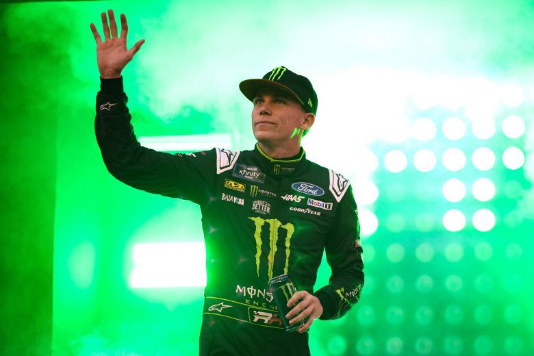 Riley Herbst waves to fans before a NASCAR Xfinity Series race.