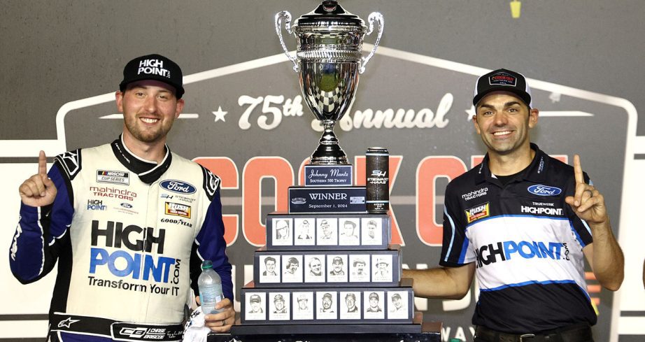 Chase Briscoe and Richard Boswell pose with the trophy for the Cook Out Southern 500 at Darlington Raceway.