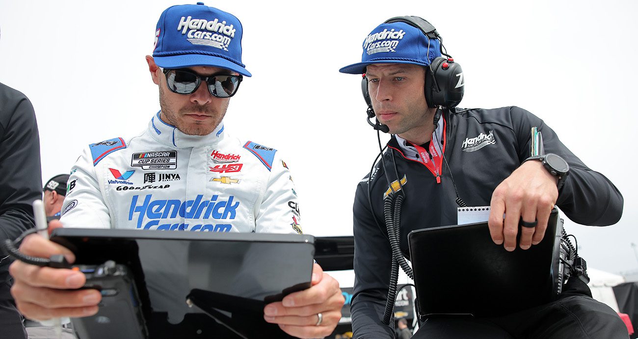kyle larson and cliff daniels look at data on a tablet