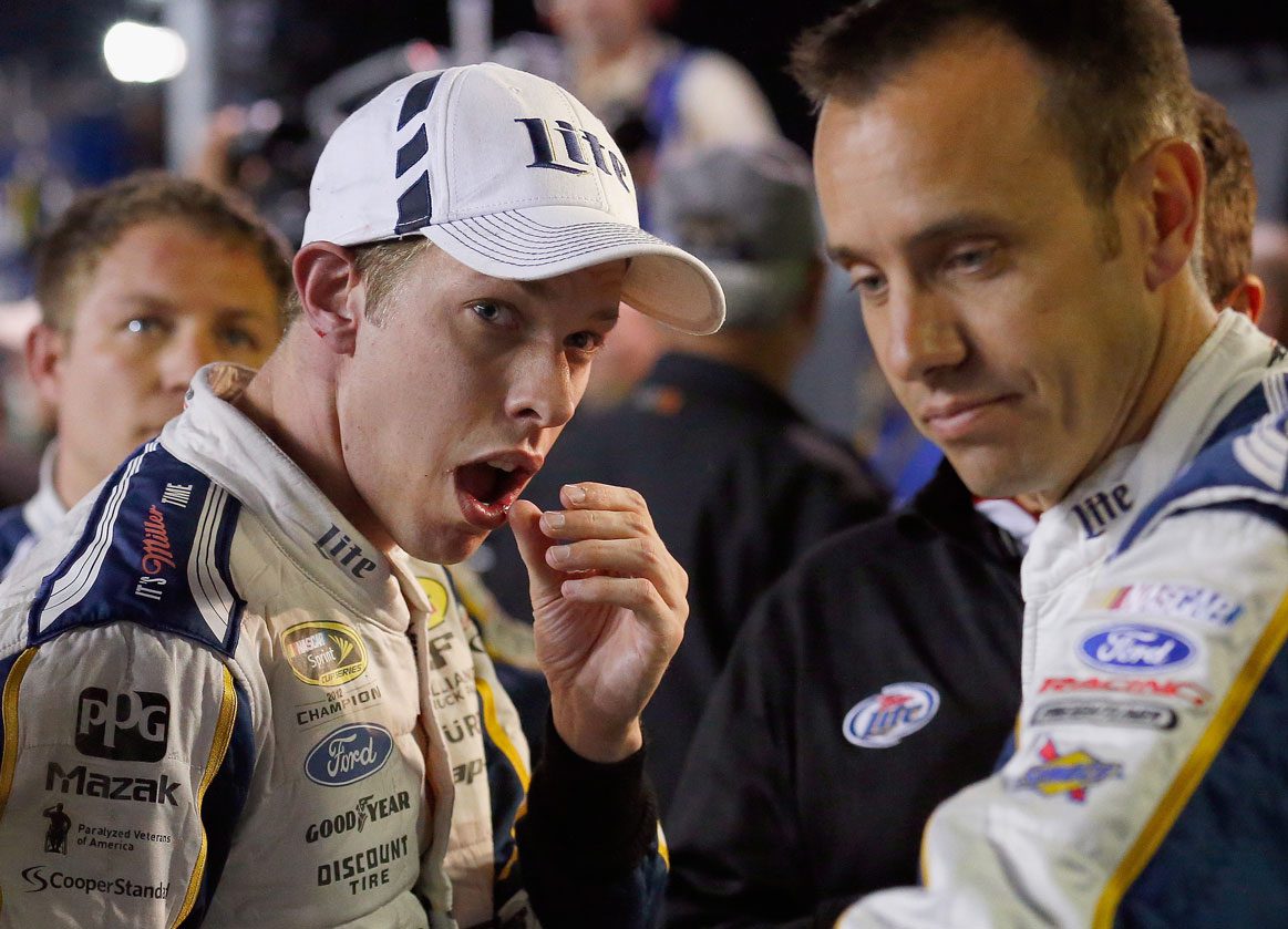 Brad Keselowski touches his lip after fight following 2014 Texas playoff race.