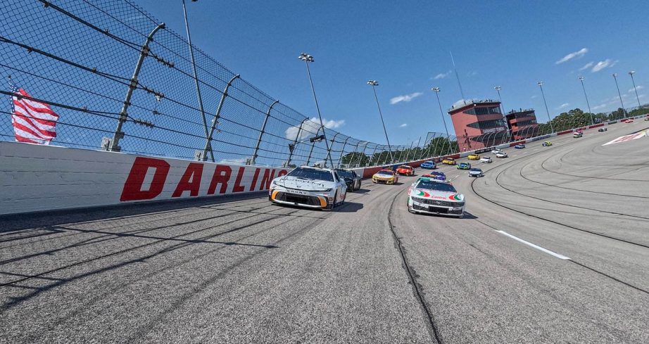 NASCAR Cup Series cars drive through the turns at Darlington Raceway.