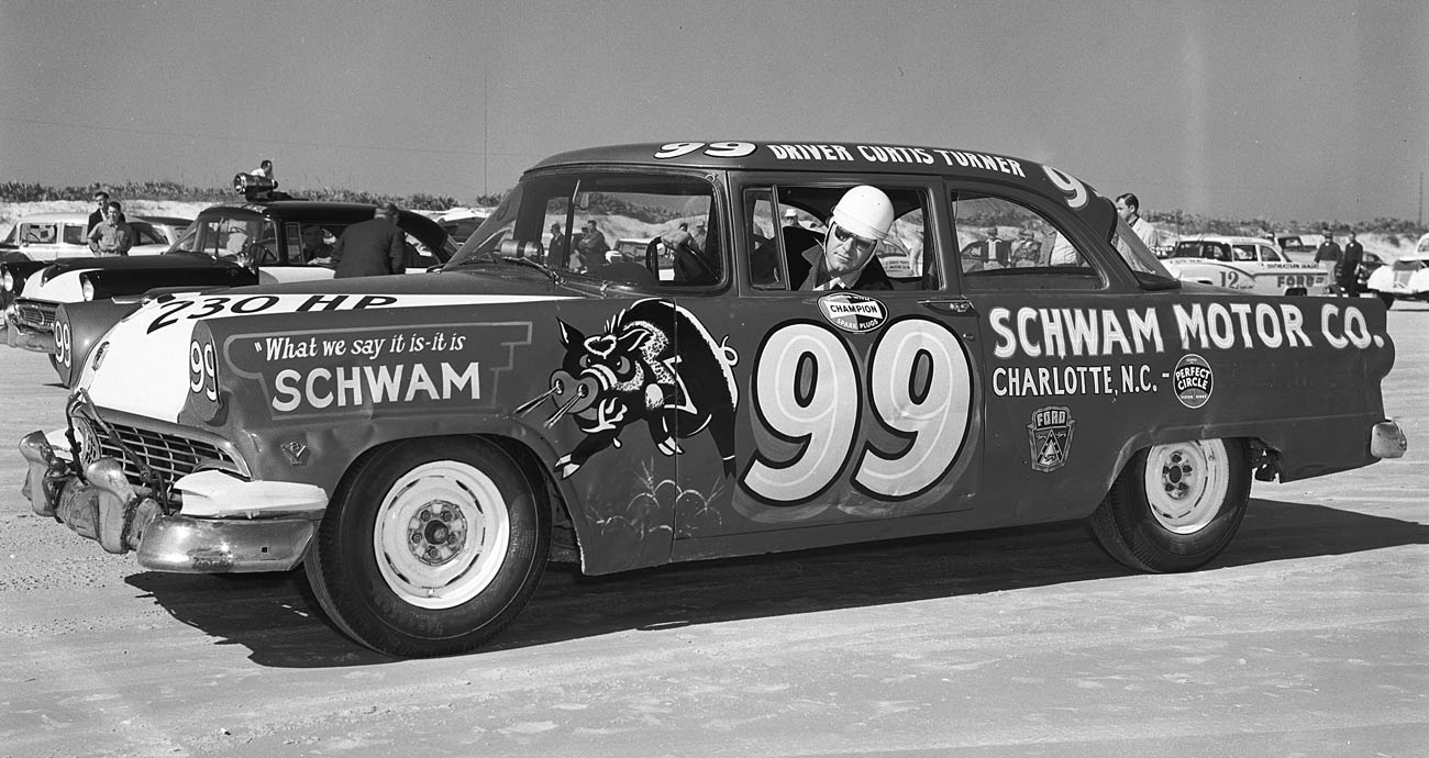 Curtis Turner poses for a photo in his No. 99 Ford.