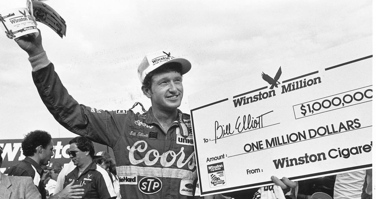 Bill Elliott poses with the $1 million-dollar check following his NASCAR Cup Series victory at Darlington Raceway.