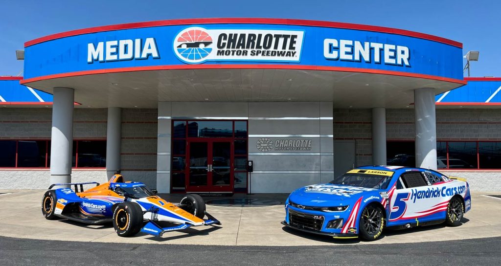 A general view of the No. 17 Arrow McLaren Chevrolet (L) and No. 5 Hendrick Motorsports Chevrolet (R) in front of the media center entrance at Charlotte Motor Speedway.