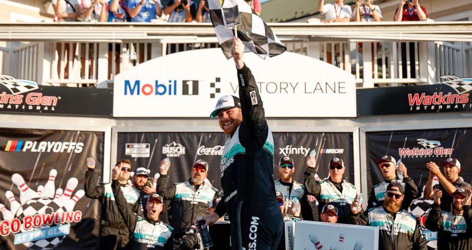 Chris Buescher hoists the checkered flag in Victory Lane at Watkins Glen International.
